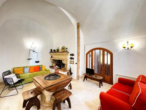 a living room with a couch and a table at La Torretta - Authentic Historic House with Panoramic Sea-View Terrace in Otranto Old Town - Marea Stays Collection in Otranto