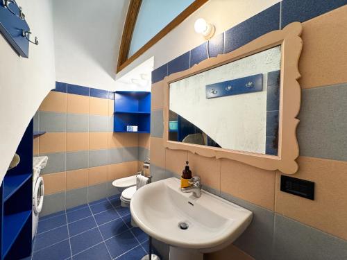 a bathroom with a sink and a toilet at La Torretta - Authentic Historic House with Panoramic Sea-View Terrace in Otranto Old Town - Marea Stays Collection in Otranto
