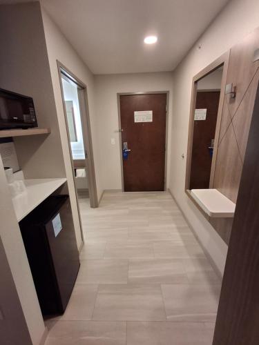 a hallway with a door and a tile floor at Holiday Inn Express Selinsgrove by IHG in Shamokin Dam