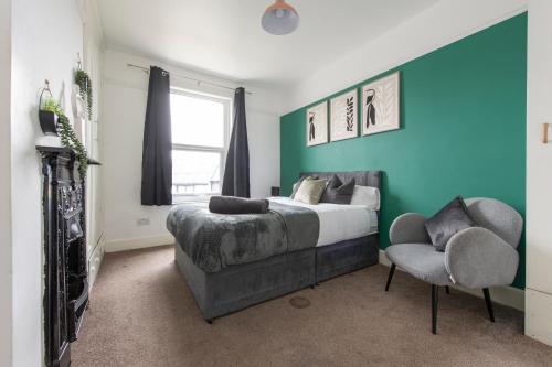a bedroom with a bed and a chair at The Haven Lodge in Gillingham