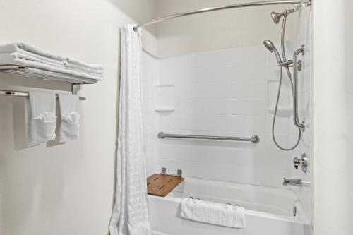 a bathroom with a shower with a shower curtain at Americas Best Value Inn Somerville Texas in Somerville