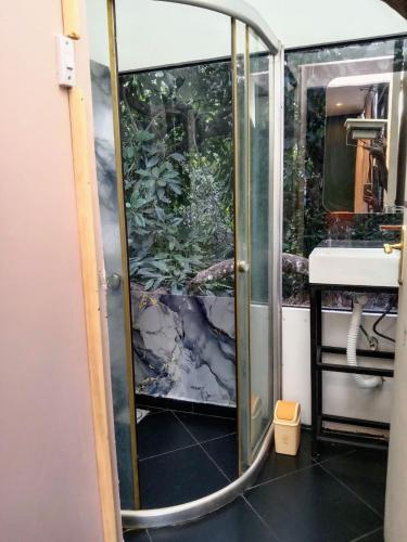 a bathroom with a shower and a sink at Lux tree house karen in Nairobi