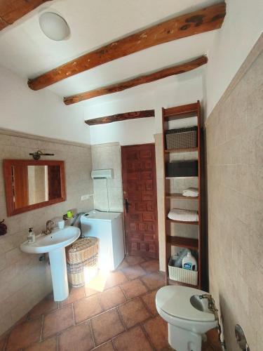 a bathroom with a sink and a toilet at Casa Mirador in Cáñar