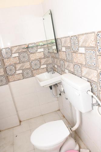 a bathroom with a toilet and a sink at Manas homes in Gwalior