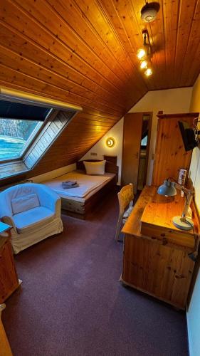 a bedroom with two beds and a desk in a room at Landhotel Sperlingsberg in Crimmitschau