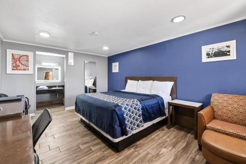 a hotel room with a bed and a couch at Western Inn by Capital O Cleburne TX in Cleburne