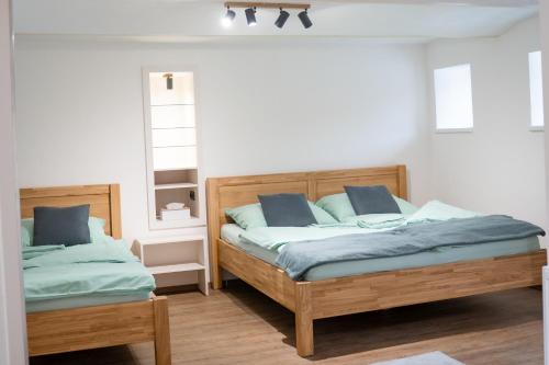 a bedroom with two beds with blue pillows at Ubytování U Mecha in Bečice