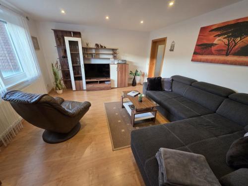 a living room with a couch and a table at EderseeGlück - Fewo 1 in Bringhausen