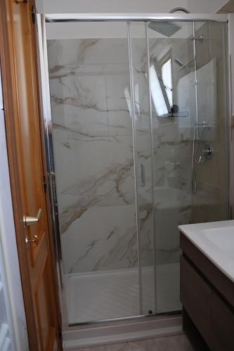 a bathroom with a shower with marble at Al Giardino b&b in Acri