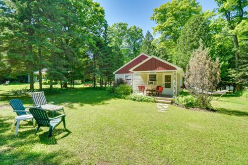 a yard with two chairs and a house at Ephraim Vacation Rental - 3 Mi to Fish Creek Beach in Ephraim
