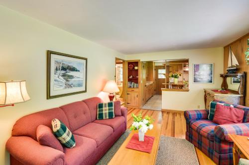 a living room with a red couch and a table at Ephraim Vacation Rental - 3 Mi to Fish Creek Beach in Ephraim