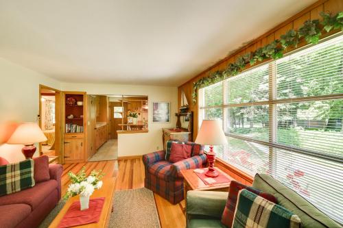 a living room with couches and a large window at Ephraim Vacation Rental - 3 Mi to Fish Creek Beach in Ephraim