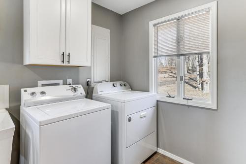 a white laundry room with two washes and a window at Waterfront Deck, Shell Knob Gem on Table Rock! in Shell Knob