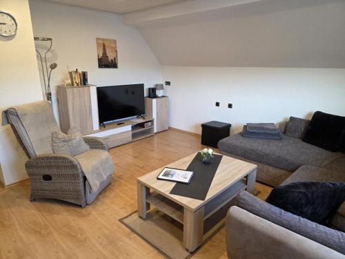 a living room with two couches and a tv at EderseeGlück - Fewo 2 in Edertal