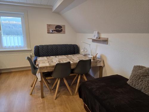 a room with a table and chairs and a bed at EderseeGlück - Fewo 2 in Edertal