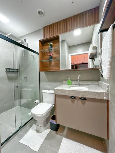 a bathroom with a toilet and a sink and a shower at Studio Moderno e Completo in Aracaju