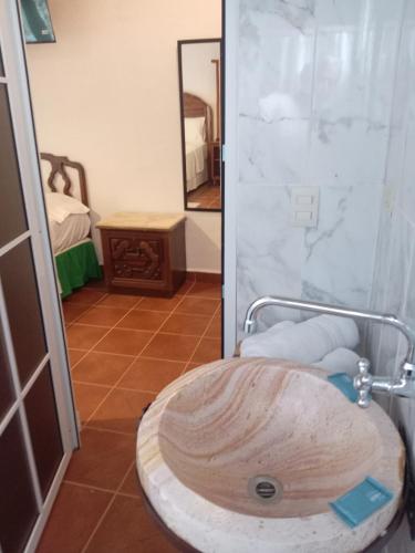 a bathroom with a wooden sink and a mirror at Casa GALLARDO in Danlí