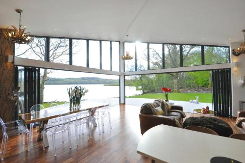 a living room with a large glass wall at Cameron North Lodge in Balloch