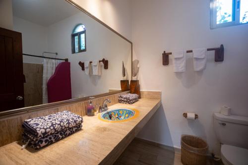 a bathroom with a sink and a mirror at Nacional Beach Club & Bungalows in Mahahual