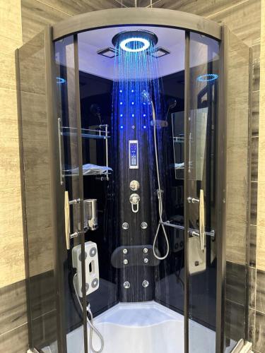a shower with a blue curtain in a room at Super Luxury Private Complex Apt In New Cairo in New cairo