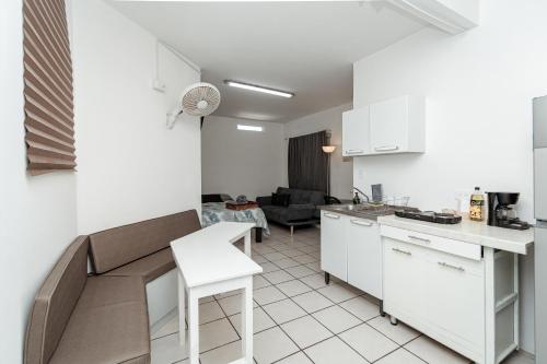a kitchen and living room with a couch and a table at Departamento Palmito in La Paz