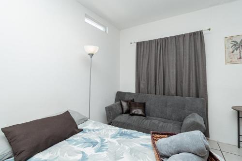 a living room with a bed and a couch at Departamento Palmito in La Paz