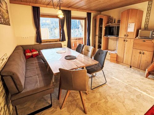 a living room with a couch and a table and chairs at Apartment Untererhof-1 by Interhome in Pankrazberg