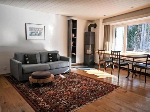 a living room with a couch and a table at Apartment Rustica by Interhome in Lenzerheide