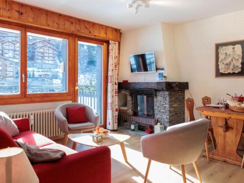a living room with a couch and a fireplace at Apartment Ecluses 2 by Interhome in Nendaz