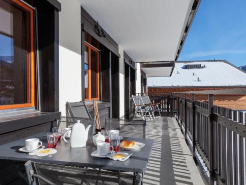 a balcony with a table and chairs on a building at Apartment Ecluses 2 by Interhome in Nendaz