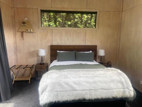 a bedroom with a large bed and a window at Alkea heights in Makarora