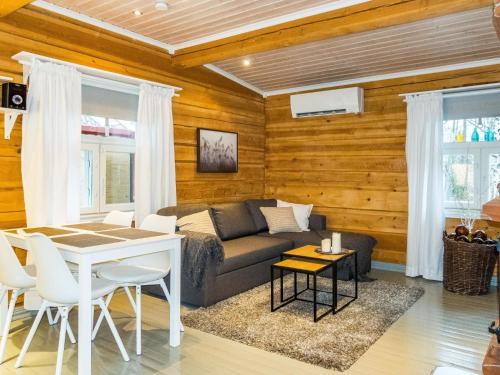 a living room with a couch and a table at Holiday Home Renkitupa by Interhome in Saarenkylä