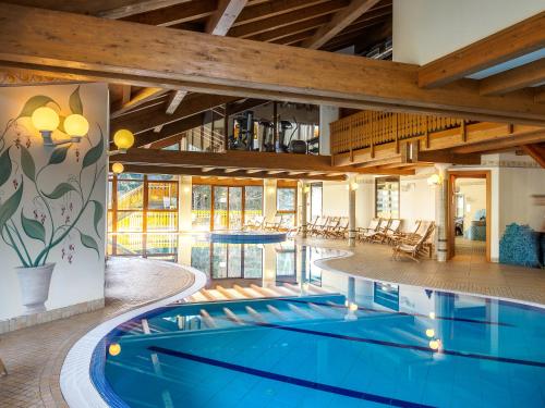 an indoor pool in a building with a swimming pool at Park Hotel in Folgarida