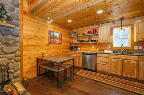 a kitchen with a table and a stove at Cozy Cub Cabin by Railey Vacations in McHenry