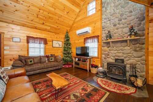 a living room with a couch and a fireplace at Cozy Cub Cabin by Railey Vacations in McHenry