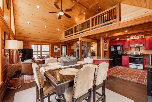 a kitchen and living room with a table and chairs at Crows Nest by Railey Vacations in Swanton