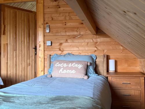a bedroom with a bed with a pillow on it at Owls Nest in Larling
