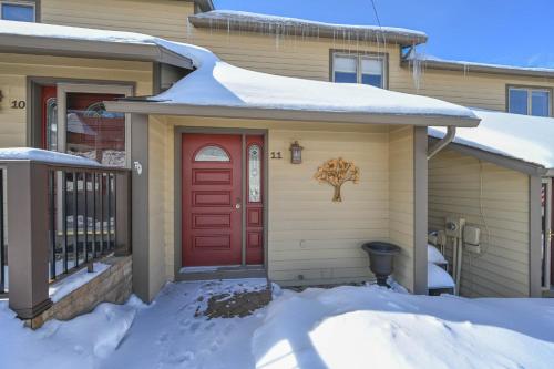 a house with a red door in the snow at DC Love Shack by Railey Vacations in McHenry