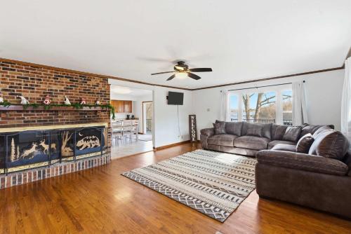 a living room with a couch and a fireplace at Lakeside Brick Retreat For 8 in Branson West