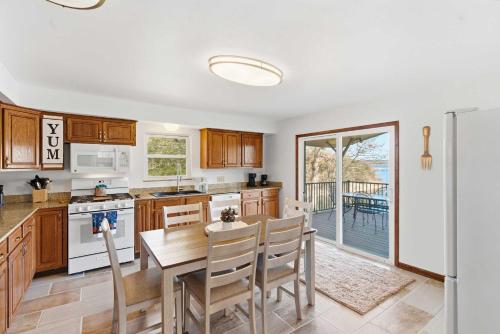 a kitchen with a table and a dining room at Lakeside Brick Retreat For 8 in Branson West