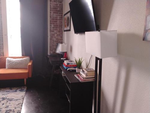 a room with a desk with a lamp and a chair at The Downtown Grizz Loft in Memphis