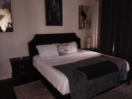 a bedroom with a large bed with white sheets and pillows at The Downtown Grizz Loft in Memphis