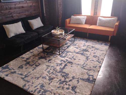 a living room with a couch and a coffee table at The Downtown Grizz Loft in Memphis