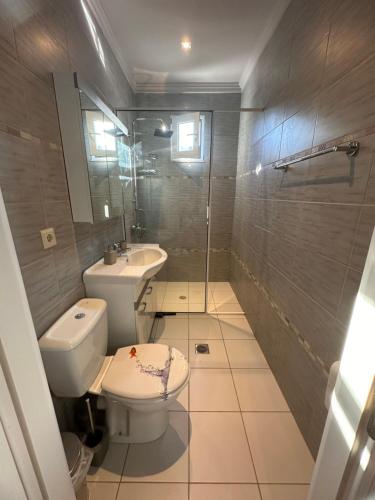 a bathroom with a toilet and a sink and a shower at Theros 1 in Xanthi