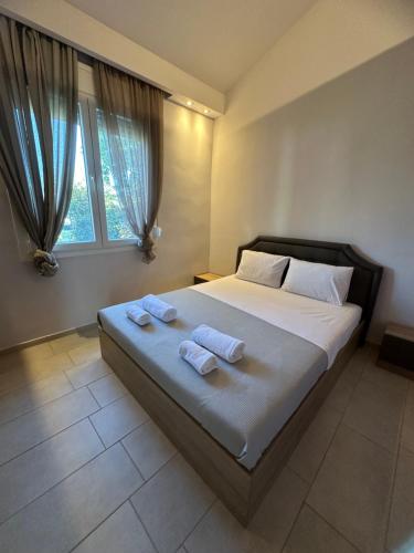 a bedroom with a bed with two towels on it at Theros 1 in Xanthi
