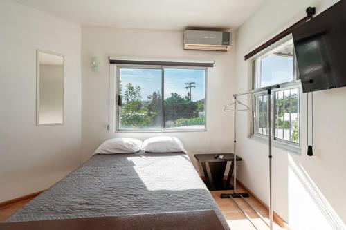 a small bedroom with a bed and a window at Departamento Palmerín in La Paz