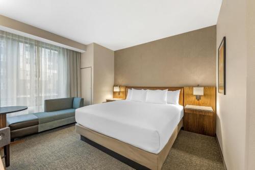 a hotel room with a bed and a couch at Drury Plaza Hotel Lincoln Downtown in Lincoln