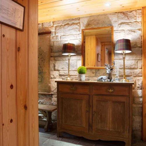 a bathroom with a sink and two lamps on a counter at The Shooting Lodge in Charminster