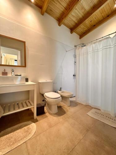 a bathroom with a toilet and a sink and a mirror at Casa Amapola in José Ignacio