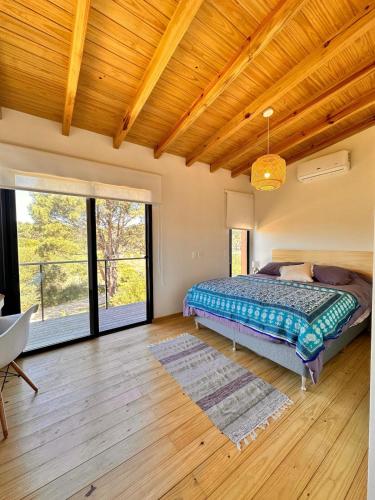 a bedroom with a bed and a large window at Casa Amapola in José Ignacio